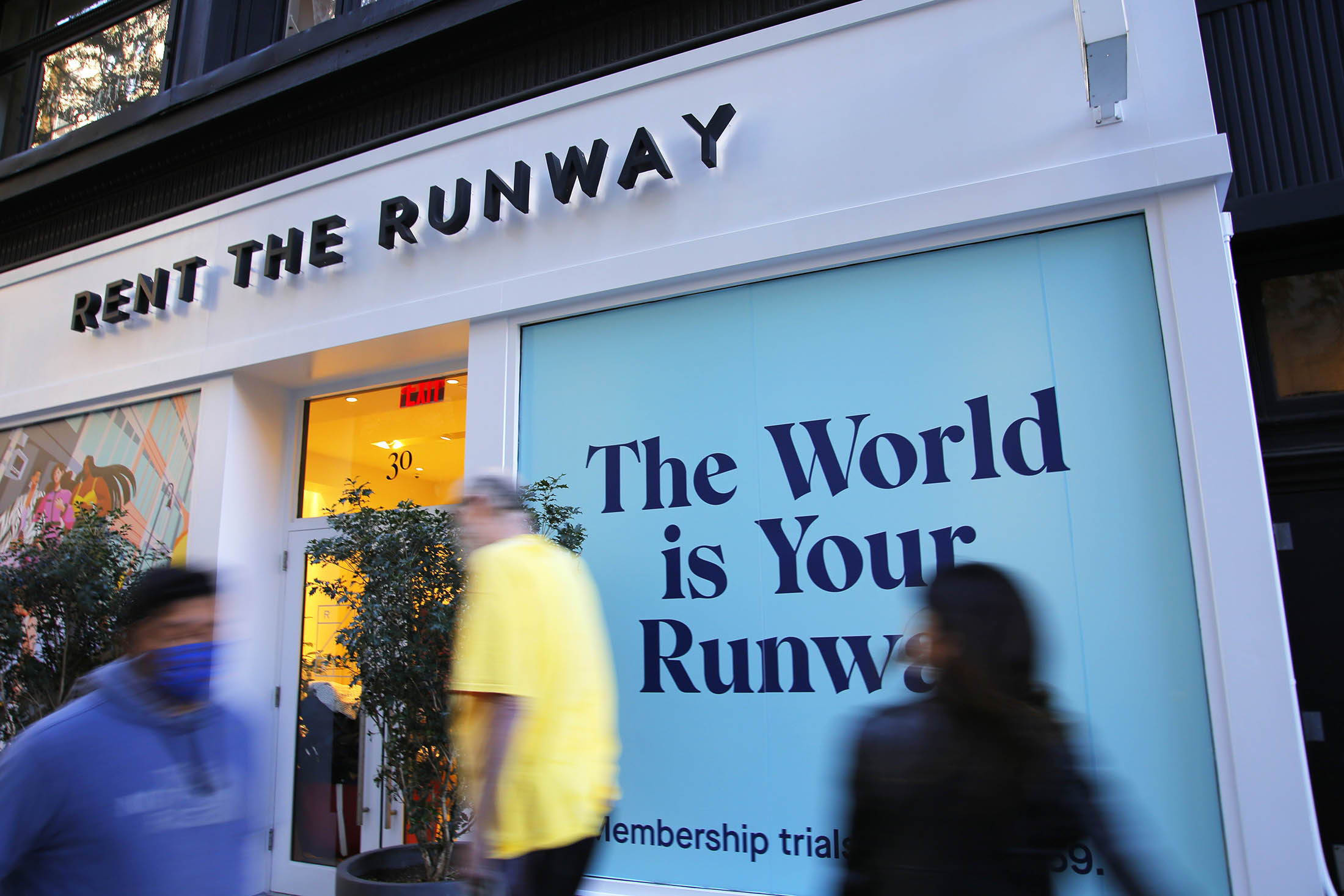 NEW YORK, NEW YORK - OCTOBER 22: People walk past the Rent the Runway store on October 22, 2021 in New York City. Rent the Runway filed an initial public offering on Monday. The company plans to offer 15 million shares at $18 to $21 with a valuation that could  reach $1.3 billion. (Photo by Michael M. Santiago/Getty Images)